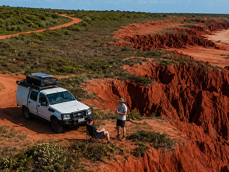 Travellers camping beside a 4WD camper at the red cliffs of James Price Point near Broome