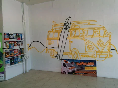 Campervan mural and brochures on wall at Tribal Travel