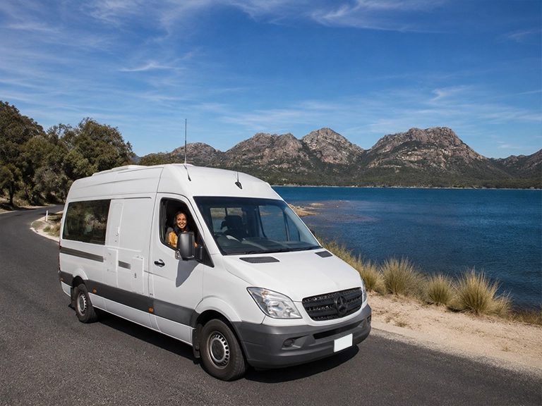 Campervan rental driving along Coles Bay Road with the Hazards mountains in Freycinet National Park