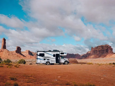 Road Bear RV rental in the USA at Valley of the Gods, Utah, surrounded by red rock formations