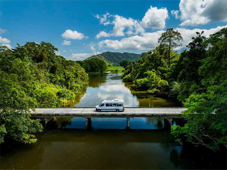 Britz Hitop campervan crossing the Russell River bridge on Bramston Beach Road in Far North Queensland, Australia